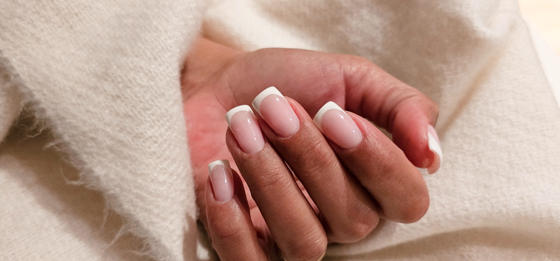 Close-up of BIAB nails with a soft French tip and a flawless manicure, professionally done at Casa de Coco nail studio.